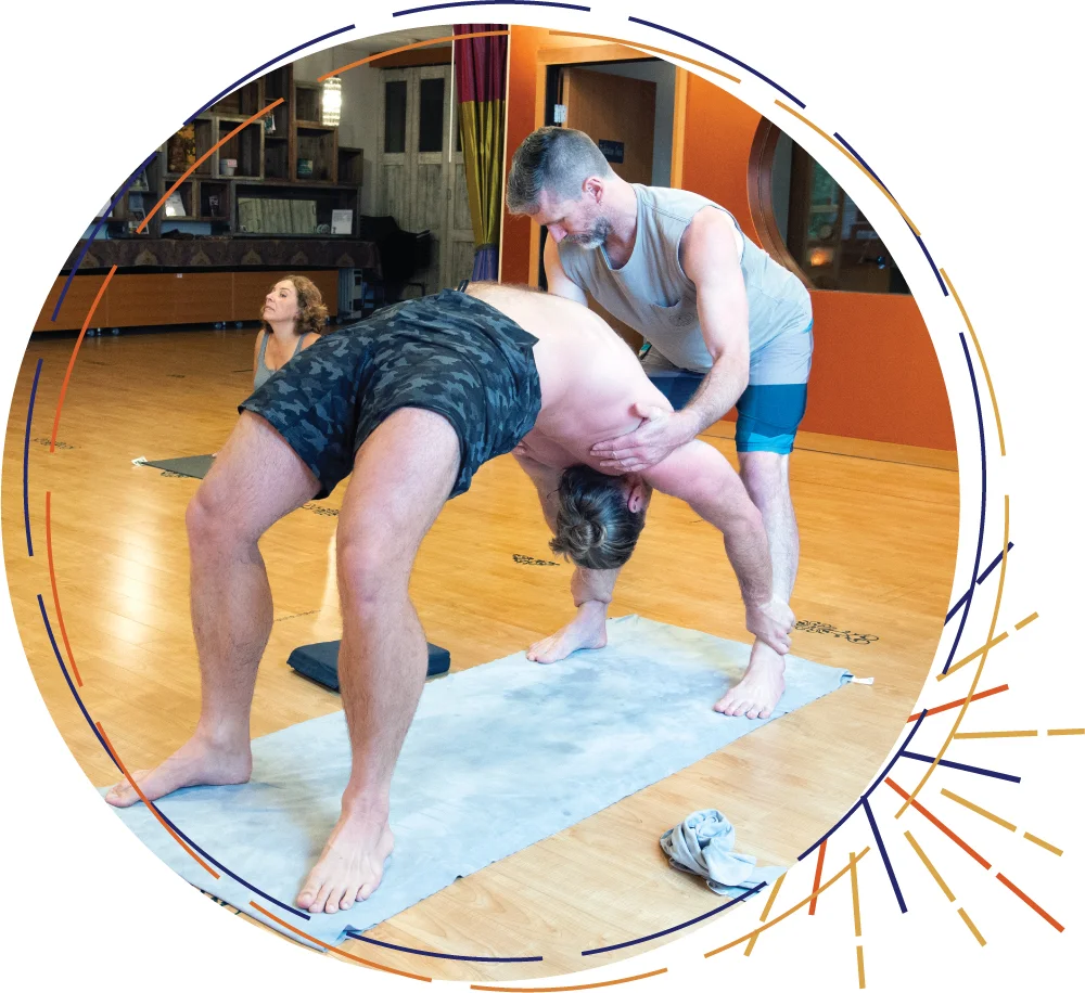 first light yoga, geoff assisting a student in backbending, ashtanga vinyasa yoga